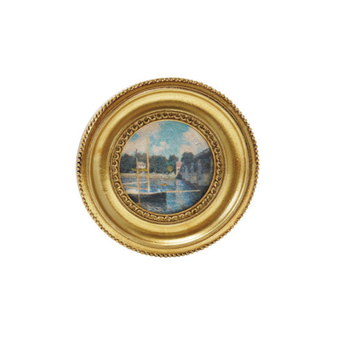 Decorative art magnet with a scenic design inside a gold frame on a white background
