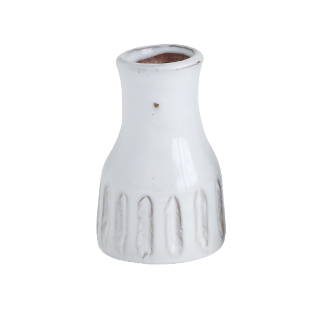 White ceramic vase with textured design on a white background