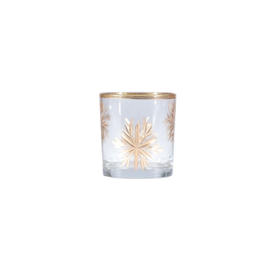 Clear glass candle holder with gold rim and snowflake design on a white background