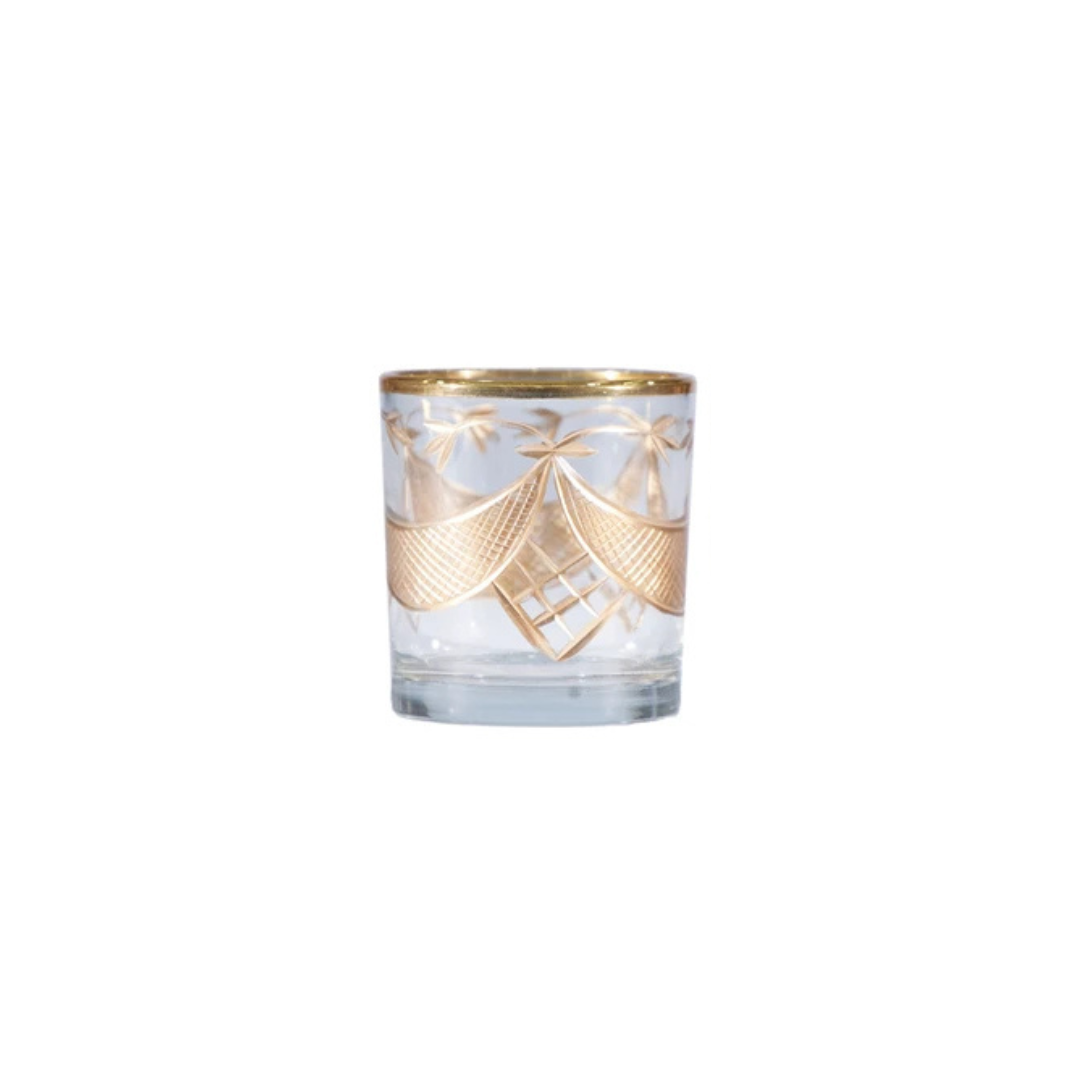 Clear glass candle holder with gold decorative elements on a white background