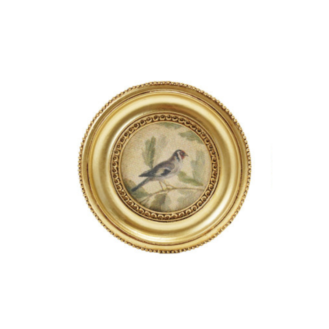 Decorative art magnet with a gold frame and a bird illustration on a white background