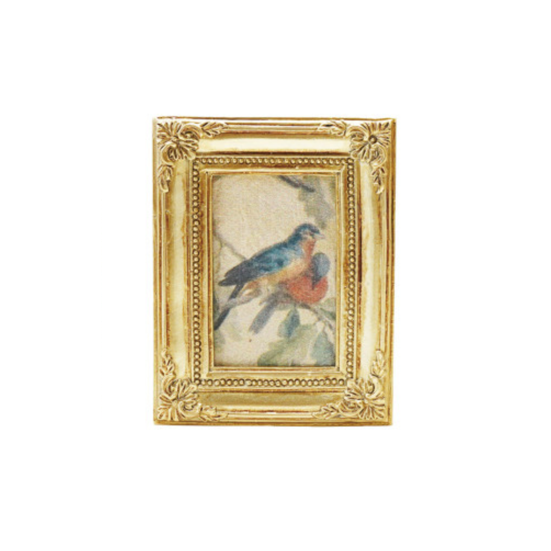 Decorative gold framed art magnet with a small painting of a bird on a white background