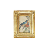 Decorative gold framed art magnet with a small painting of a bird on a white background