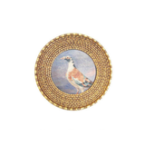 Round woven art magnet with a bird illustration on a white background