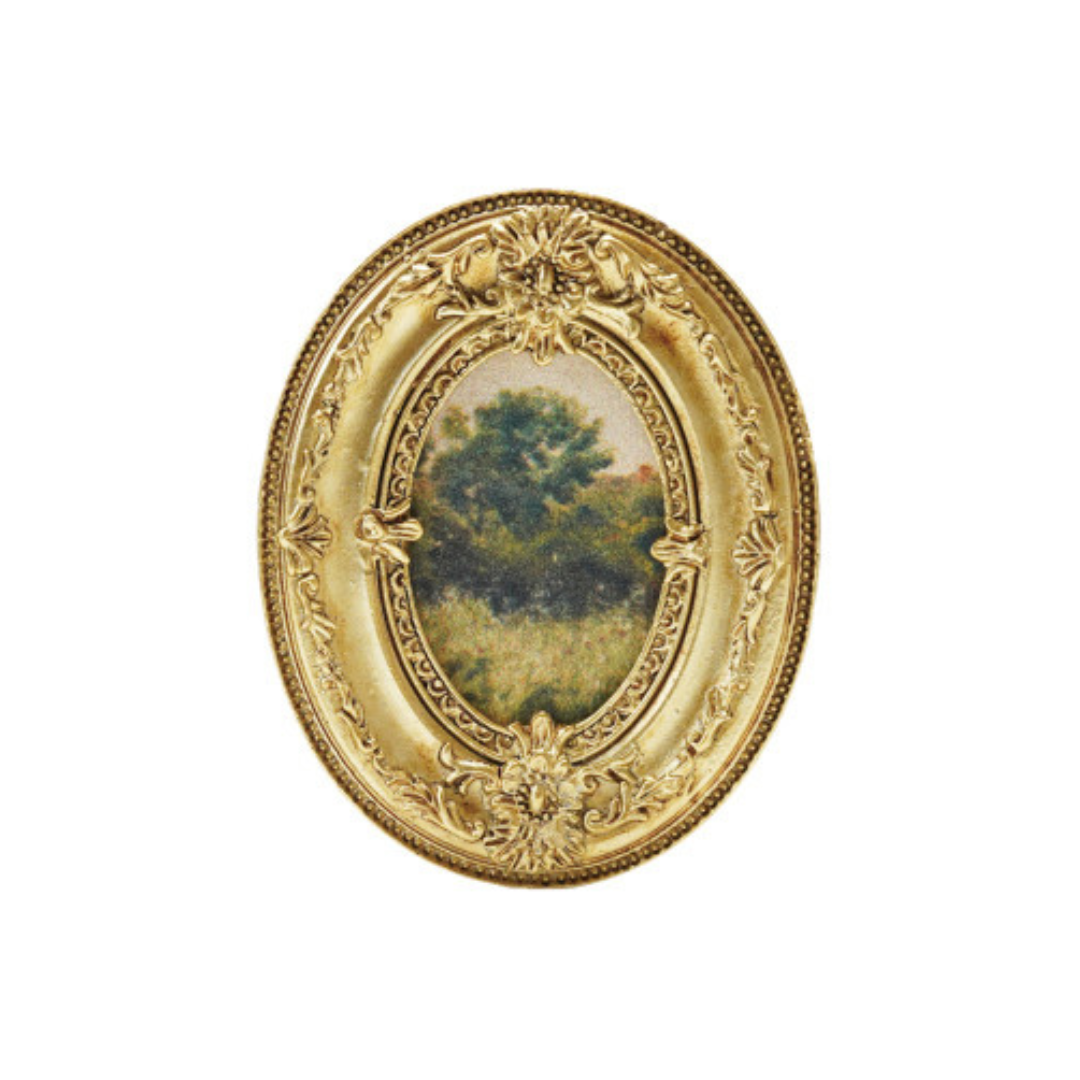 Decorative gold framed art magnet with a scenic background on a white background