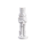 White ceramic nutcracker figurine on a white background