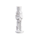 White ceramic nutcracker figurine on a white background