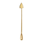 Gold Christmas tree-shaped spoon on a white background