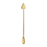 Gold Christmas tree-shaped spoon on a white background