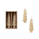 Set of tree-shaped candles with gold accents, one in a box and two on a white background