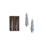 Set of Christmas tree-shaped candles, one in a box, on a white background
