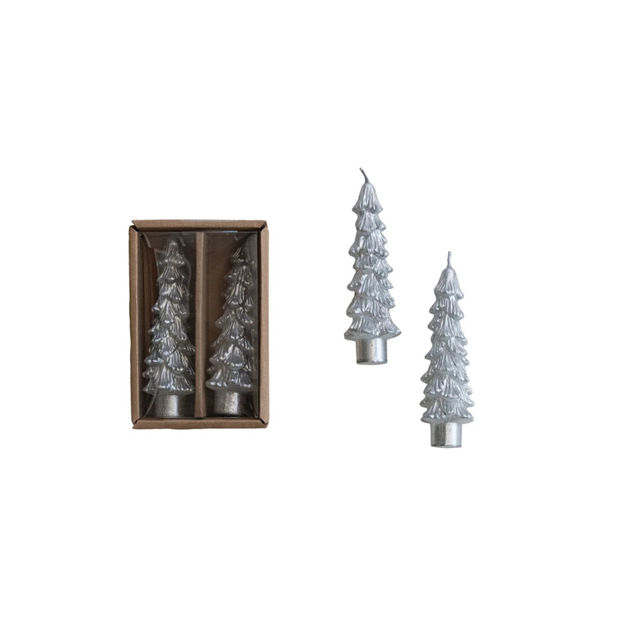 Set of Christmas tree-shaped candles, one in a box, on a white background