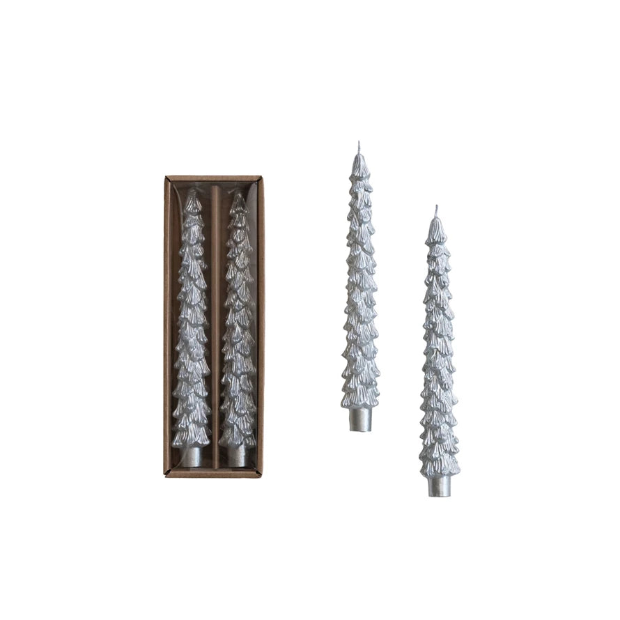 Set of decorative candles shaped like Christmas trees with packaging on a white background