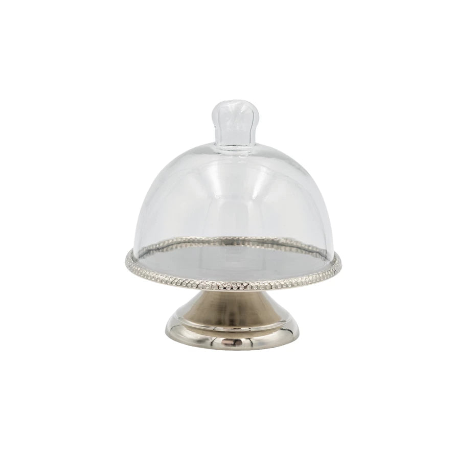 Clear glass dome with silver base on a white background