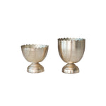Two metallic decorative vases on a white background