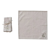 Set of linen placemats with embroidered deer design on a white background