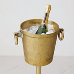 Bottle of champagne in a gold ice bucket on a white background