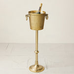 Brass ice bucket with stand on a white background