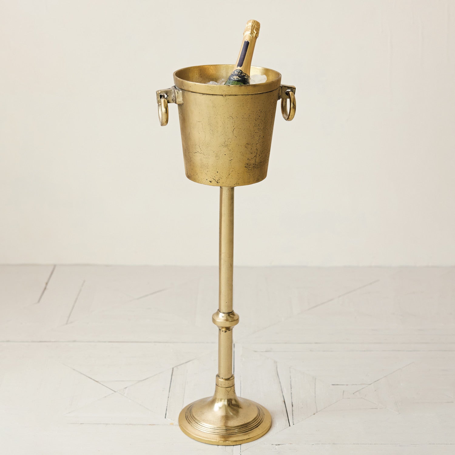 Brass ice bucket with stand on a white background