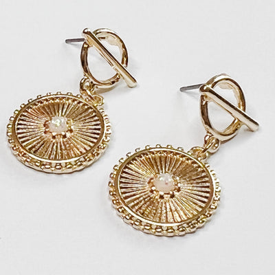 gold dangle hoops with an opal centered in a textured gold circular charm