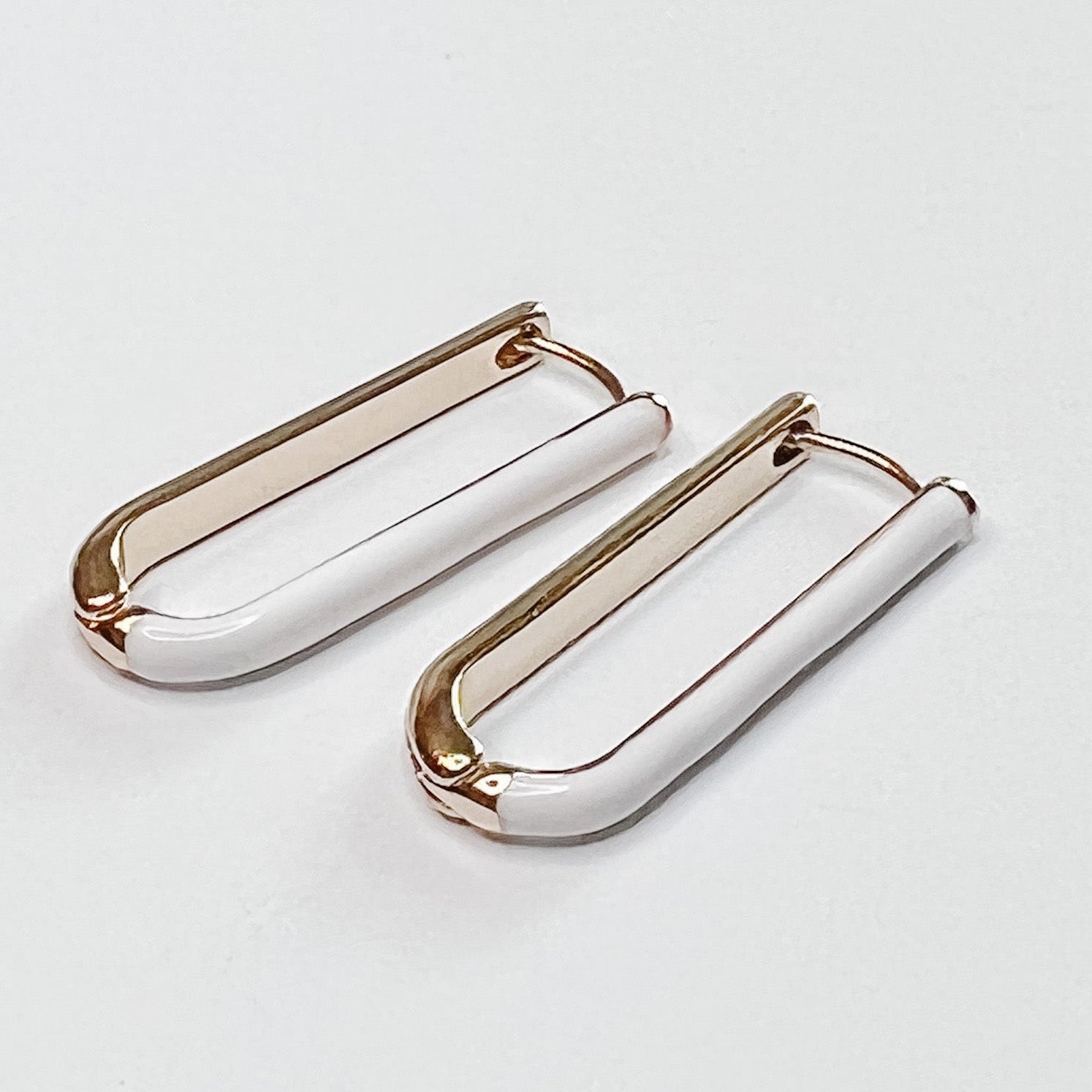 oval Huggie Hoops with white and gold coloring