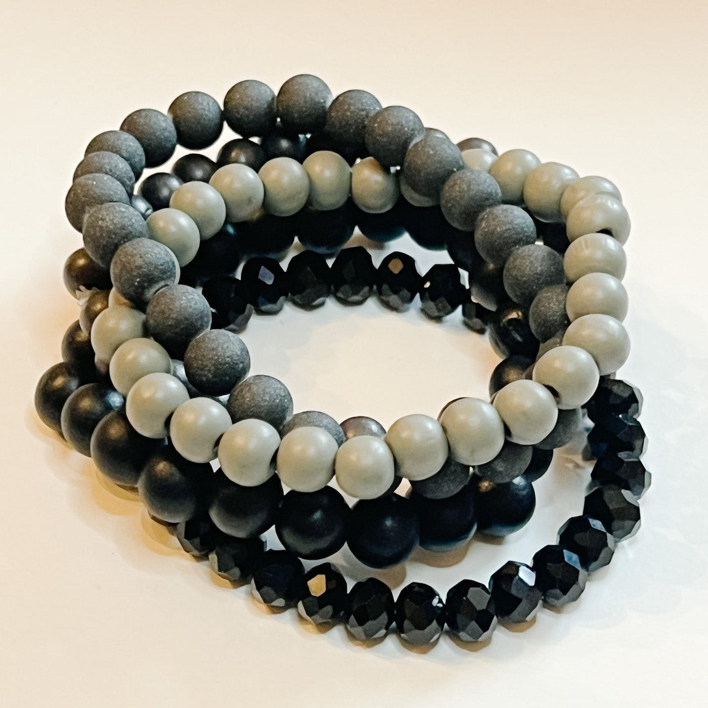 five strand beaded stack with shades of black and gray.