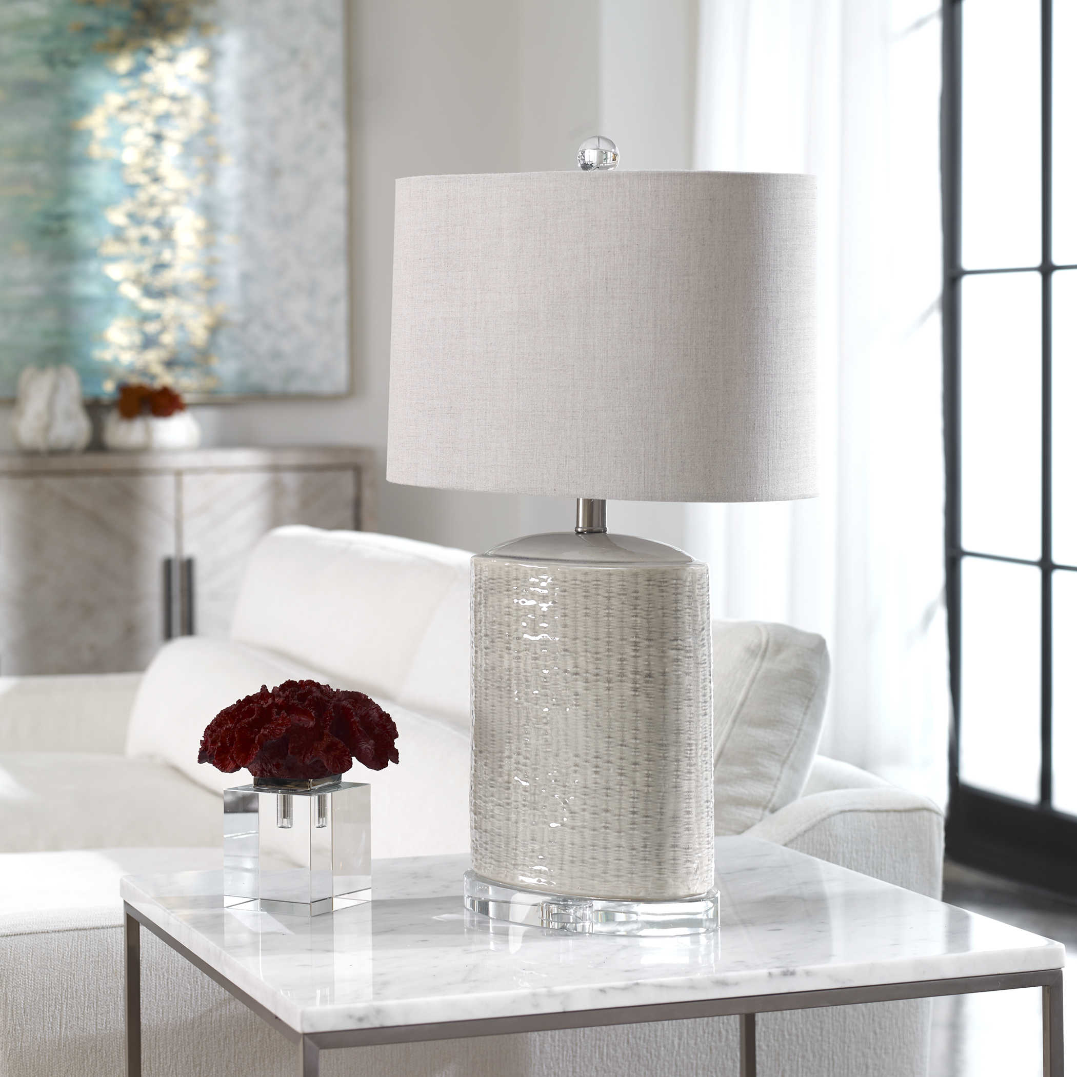 Lamp, Modica - Danshire Market and Design , light taupe gray ceramic lamp , 26" HIGH, light taupe-gray glaze, with brushed nickel plated accents and crystal details. The oval hardback drum shade is a beige linen fabric