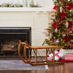 Wooden sleigh in front of a Christmas tree and fireplace