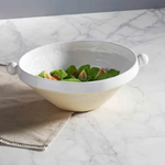This Bead Handle Serving Bowl is a designer favorite for Spring. The glazed and exposed stoneware serving bowl features large bead side handles. The bottom of the stoneware serving bowl features an exposed terracotta section that contrasts the crisp white details on the rim. Dimensions	4 1/2" x 12" dia Material	Stoneware Care Instructions	Dishwasher safe. Microwave safe.